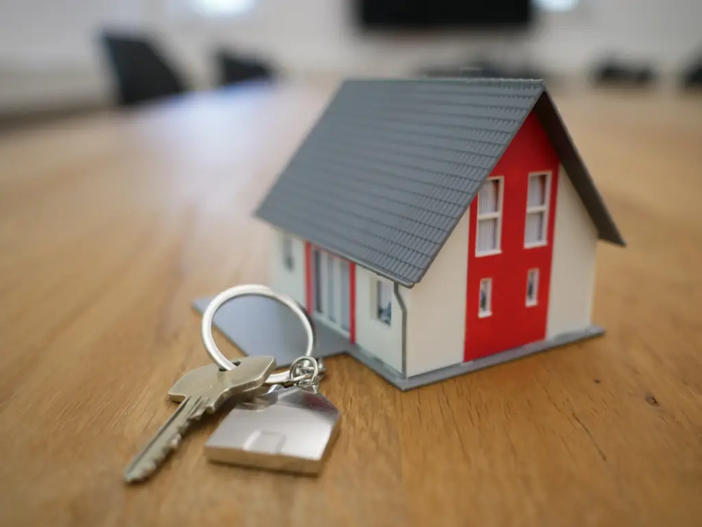 house keys placed next to a miniature home